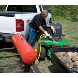 Gas can mounted on lawnmower trailer can fill a mower with gas by gravity.