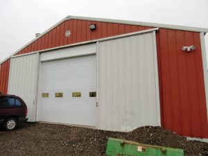 Rolling doors on the side and an overhead door installed in the middle.