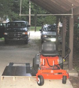 Wheel chair lift next to a zero turn lawn mower