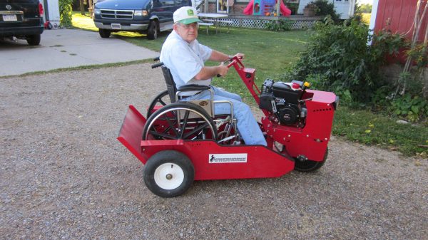 A guy in a wheelchair parked in the powerhouse while driving it.