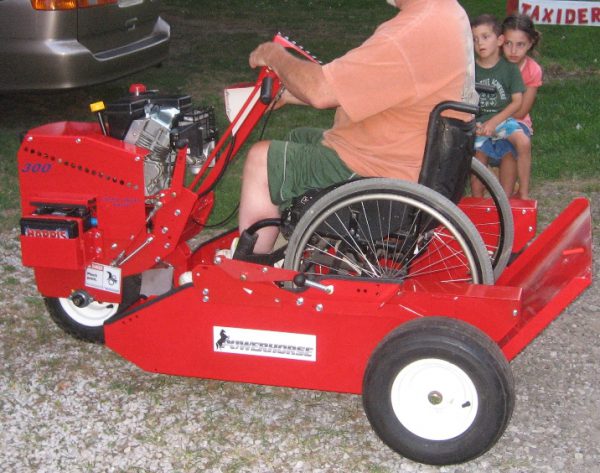 A guy in a wheelchair parked in the powerhouse while driving it.