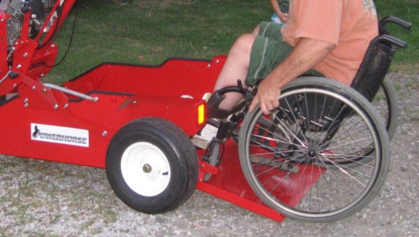 A guy pushing his wheelchair into the powerhouse wheelchair driver.