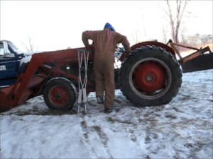 Climbing onto a tractor with crutches.