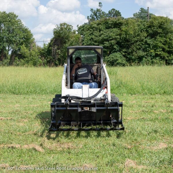 Mini Skid Steer Grapple attached to a skid steer with a person driving it.