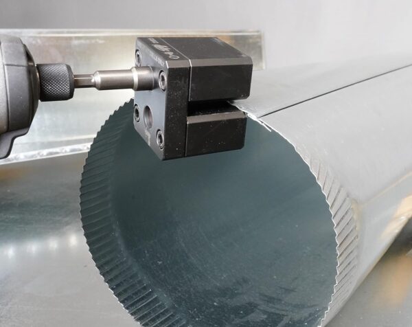 An impact power assisted crimper crimping the edge of an object.