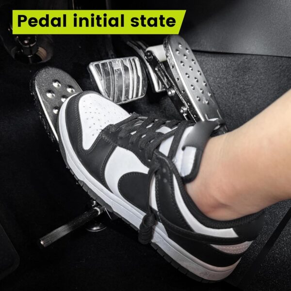 A left foot accelerator pad installed in a vehicle with a person's left foot resting on the pedal in the initial state.