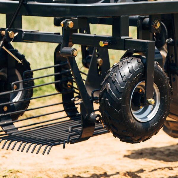 The PTO powered potato digger is lifted above the ground while it's hauled out to the field.