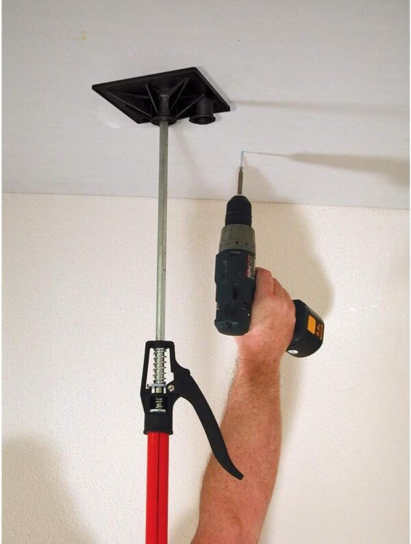 A guy has the support tool pressed up on the ceiling while looking he's going to drill into the ceiling.