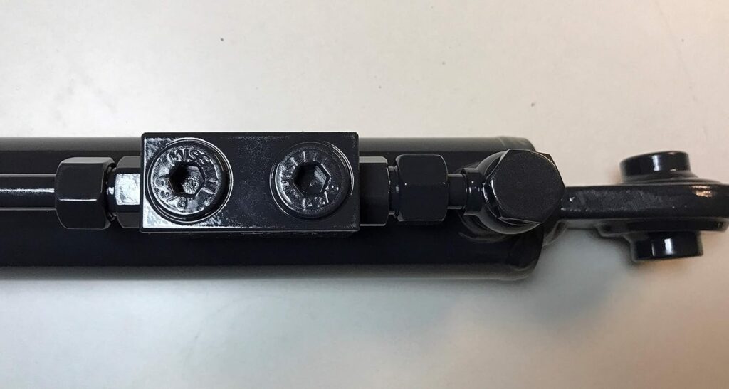 A farmer with mobility or arm impairments can use a hydraulic top link to hitch three-point implements from the comfort of his tractor seat by simply pushing a lever.